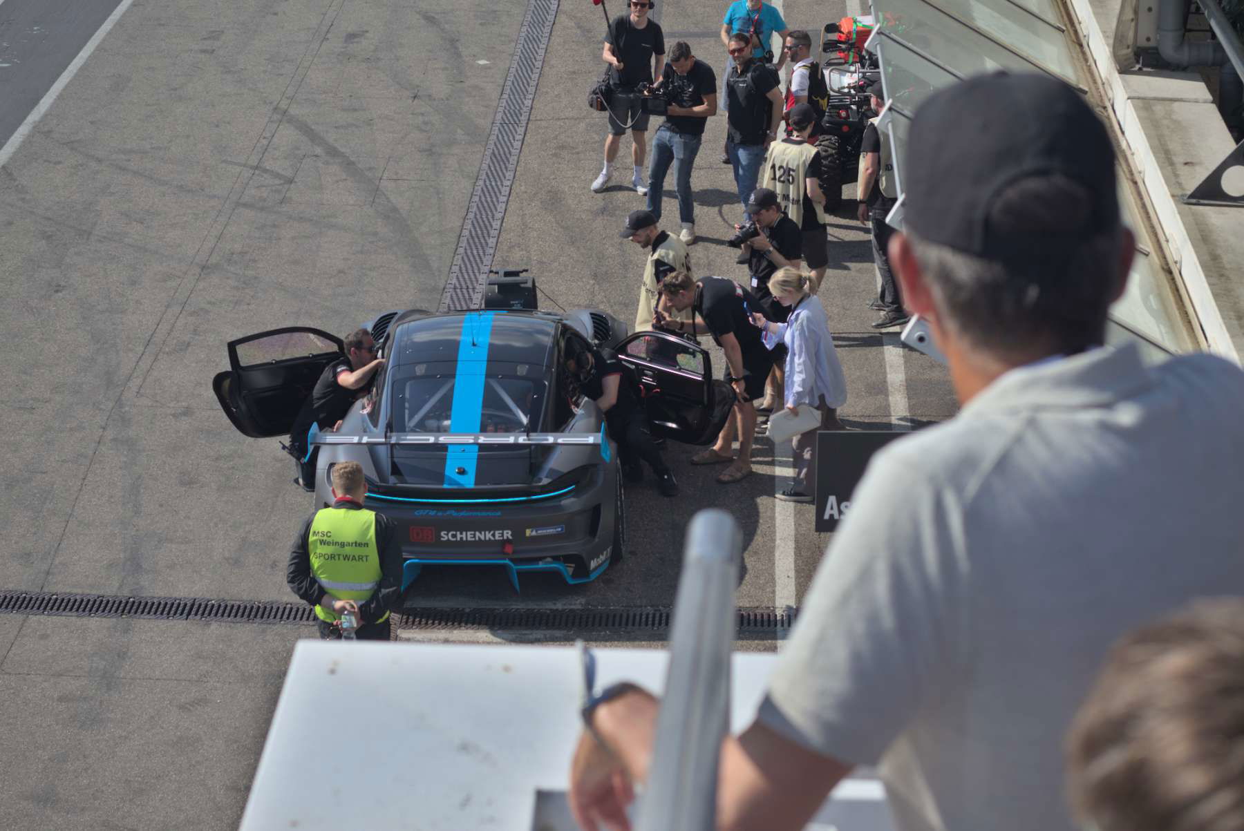 Porsche Deutschland CEO Alexander Pollich looks at the Cayman GT4 e-Performance's showrun from above