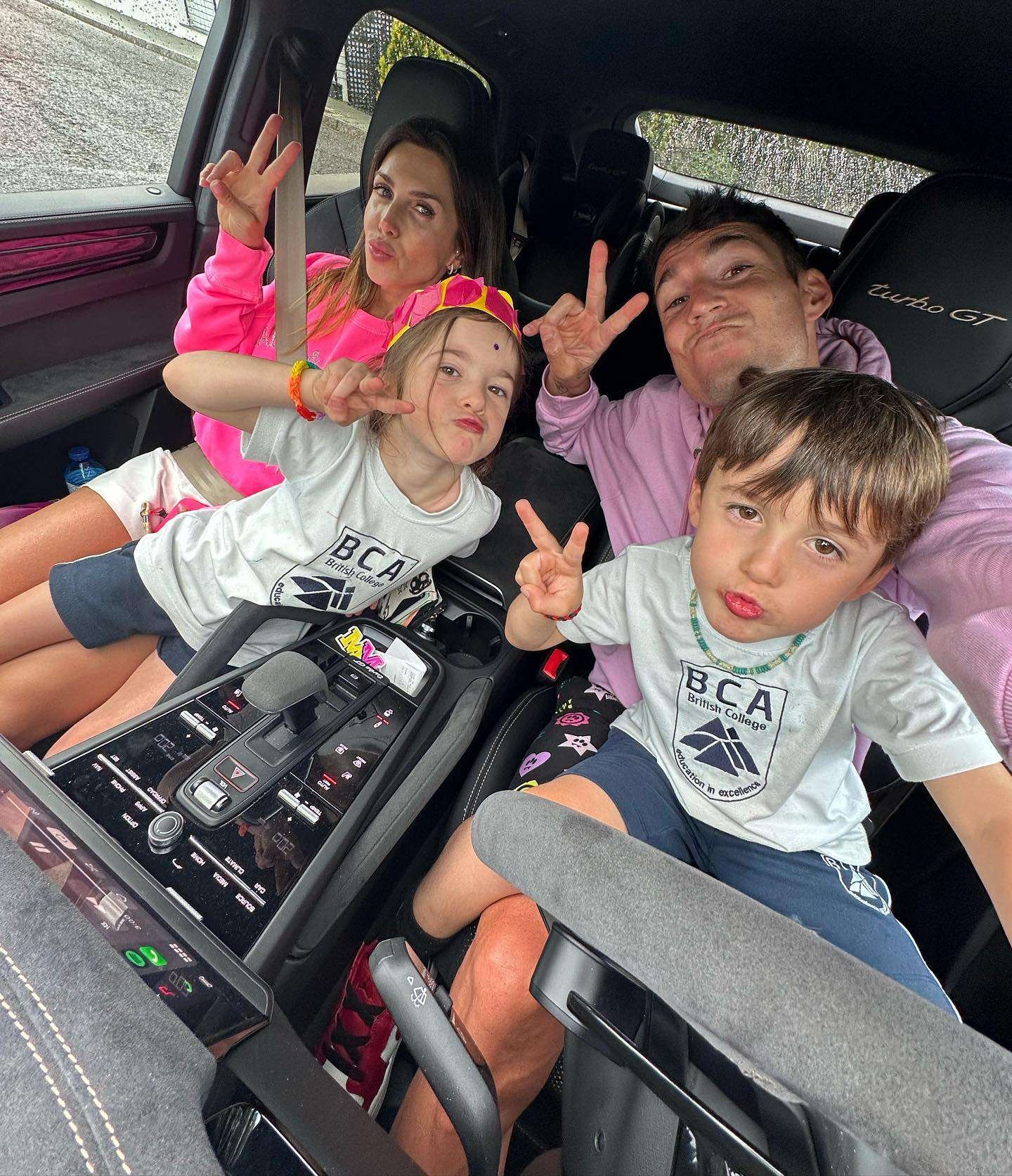 Aleix Espargaro and his wife Laura with their kids Mia & Max in their familiy car, a Porsche Cayenne Turbo GT