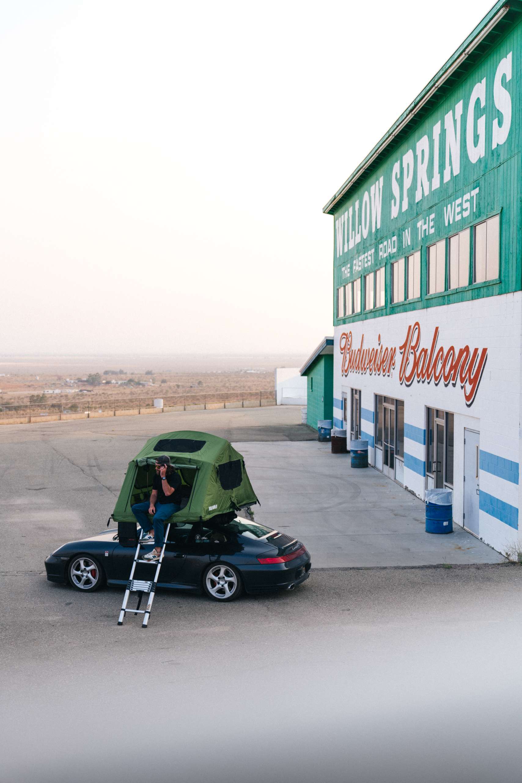 Brock Keen (996roadtrip) parking his Porsche 996 Carrera 4S with a roof tent at willow springs race way.