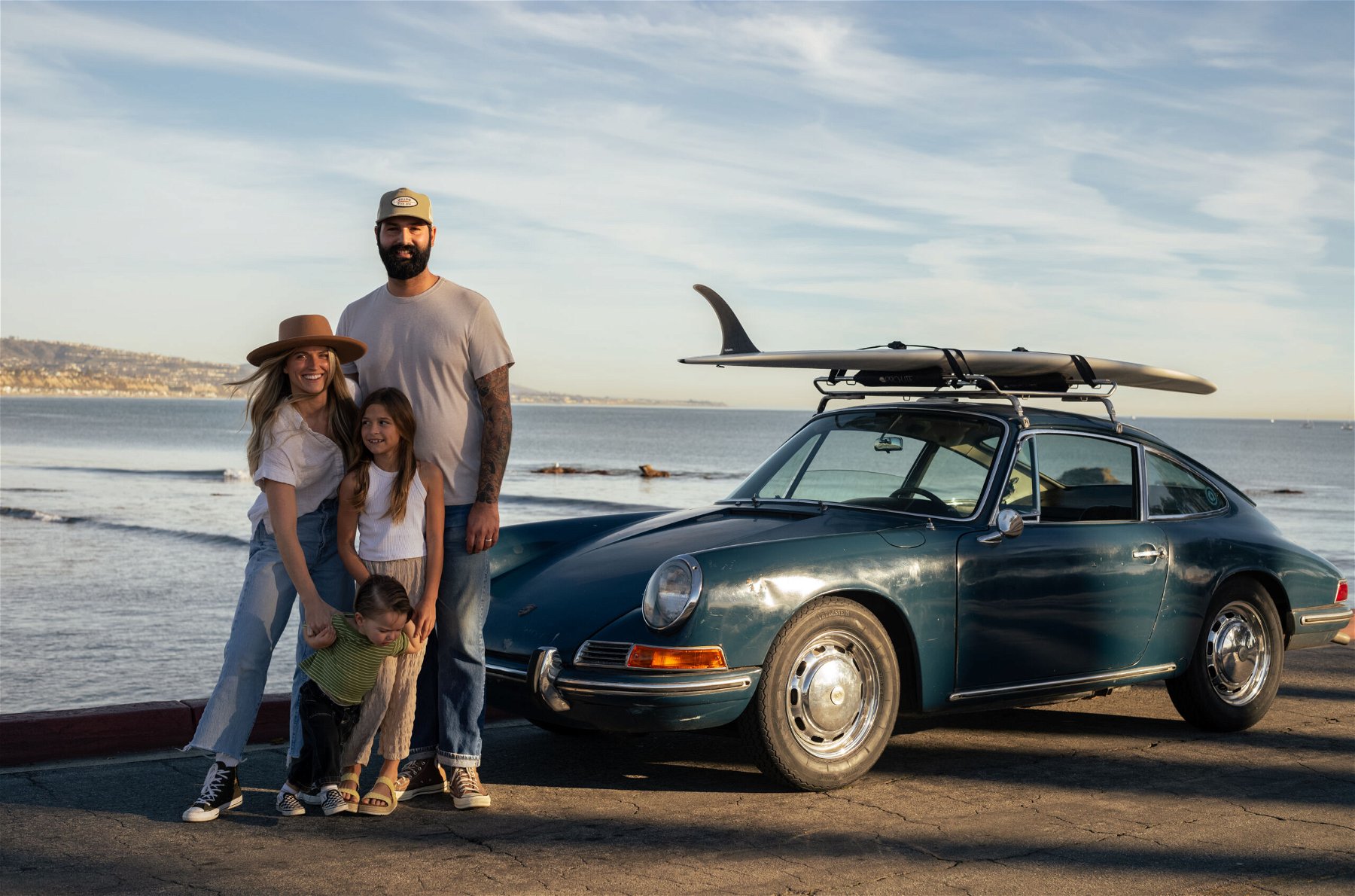Aaron Ashton and his family in front. of their Aga blue Porsche 912 