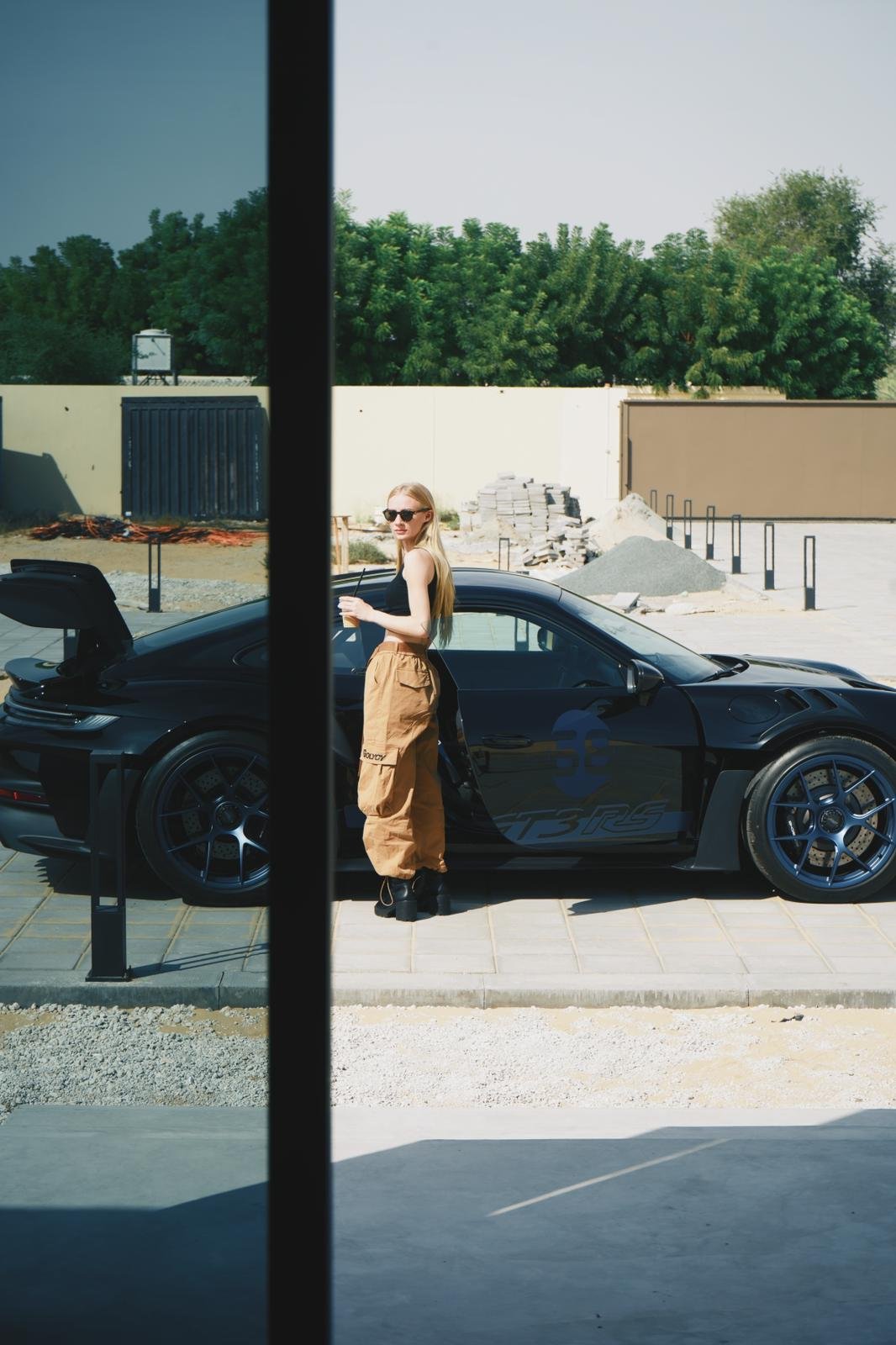 Rae Roberts next to a Porsche 992 GT3 RS