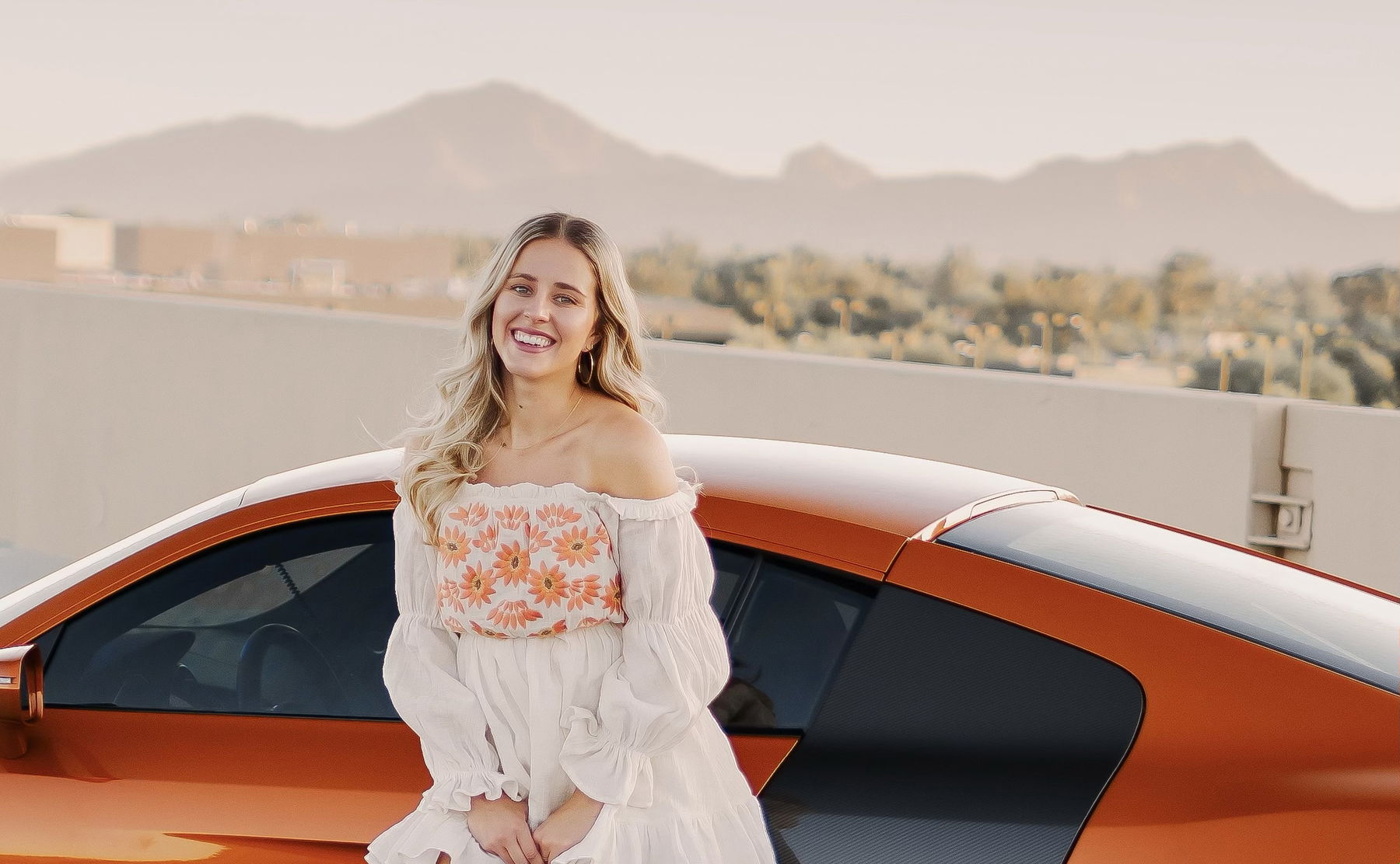 photographer Kaitlyn Clink in front of an Audi R8