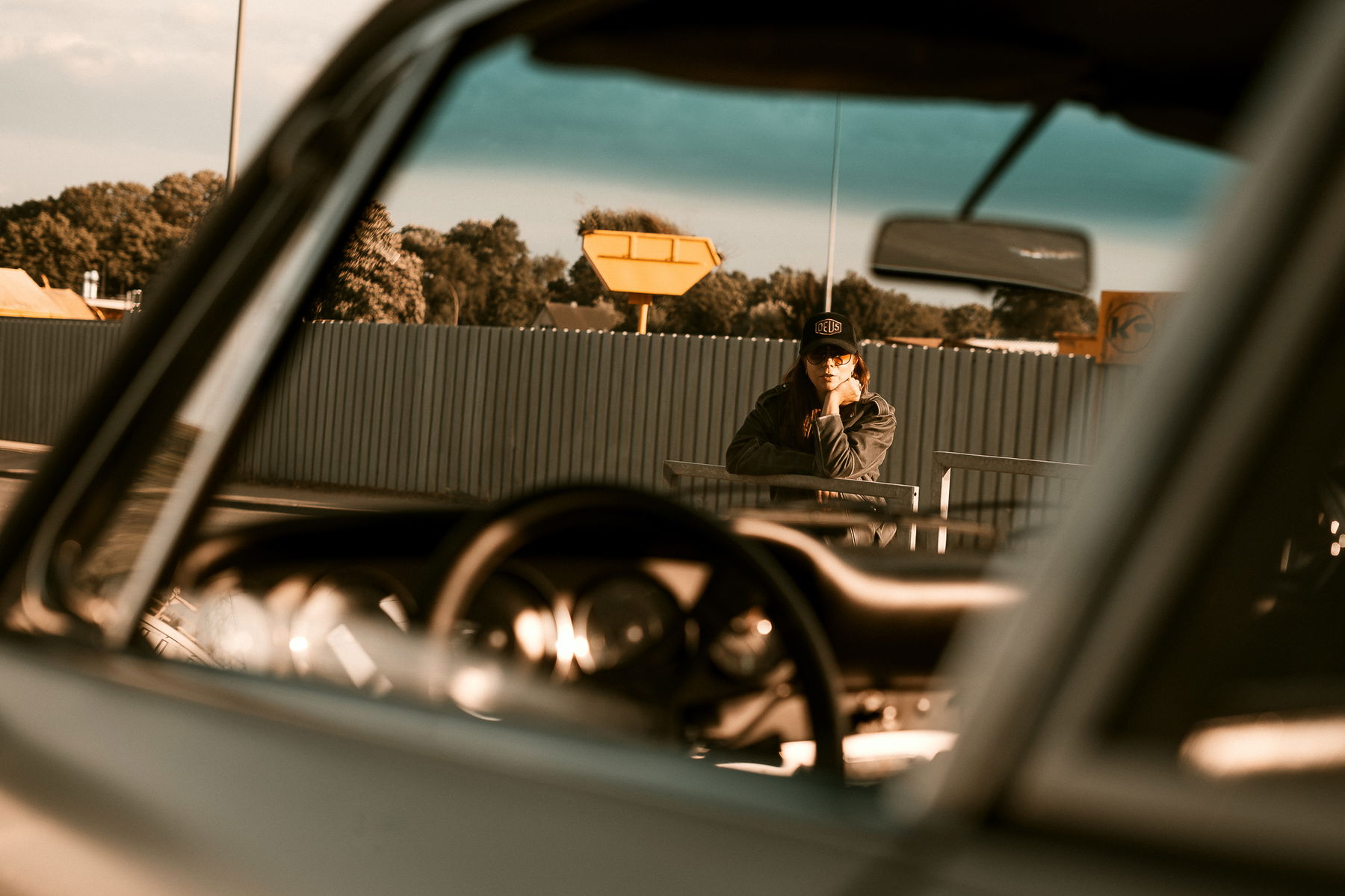 Birte Krause sitting and watching at her Porsche 912